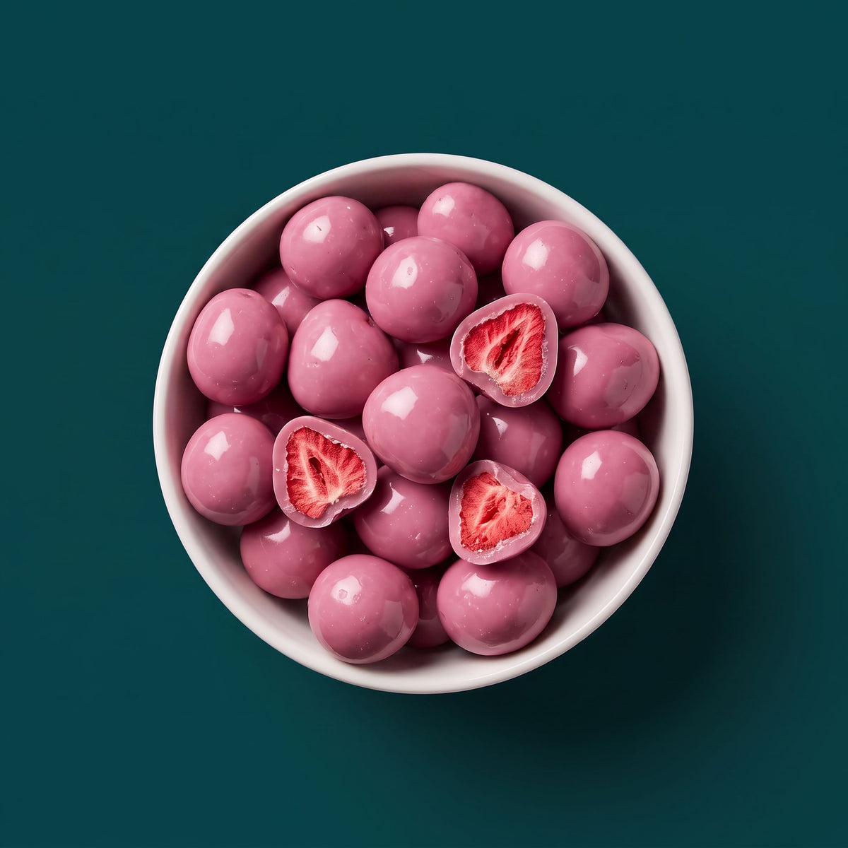 Schaal met Fruelle Vanilla Pink: gevriesdroogde aardbeien omhuld met roze witte chocolade, waarvan enkele zijn doorgesneden